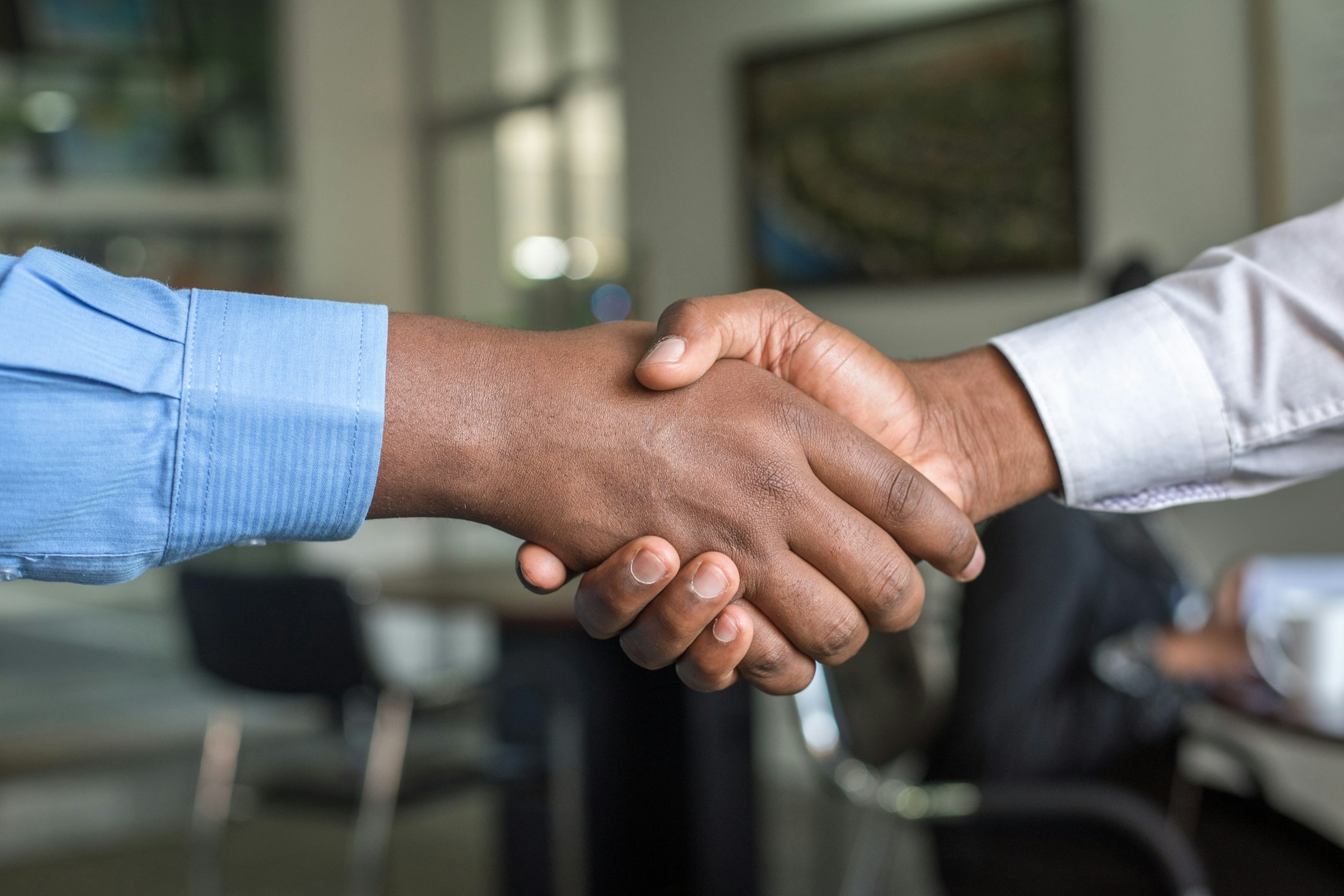 African and Chinese business professionals shaking hands - representing trusted trade partnership